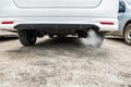 Combustion fumes coming out of car exhaust pipe, air pollution concept