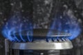 Combustion of natural gas, propane. Gas stove on a black background. Fragment of a gas kitchen stove with a blue flame, close-up. Royalty Free Stock Photo