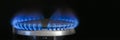 Combustion of natural gas, propane. Gas stove on a black background. Fragment of a gas kitchen stove with a blue flame Royalty Free Stock Photo