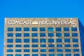 Comcast NBCUniversal sign, logo on rhombic skyscraper. NBCUniversal Media, LLC is an mass media and entertainment conglomerate Royalty Free Stock Photo