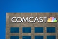 Comcast sign, logo on skyscraper facade. Comcast Corporation is an American telecommunications conglomerate based in Philadelphia