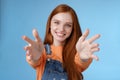 Come into arms. Charming sincere happy kind redhead girl baby sitting stretch hands camera wanna hold catch smiling Royalty Free Stock Photo