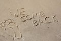 We come back - written by hand in sand on a sea beach, with a soft wave. End of rest, holiday. Royalty Free Stock Photo