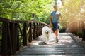 Come boy...a handsome young man walking his dog in the park. Royalty Free Stock Photo