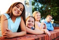 Come hangout with the cool kids. Portrait of a group of young children playing together outside. Royalty Free Stock Photo