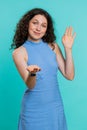 Woman showing inviting gesture with hands, ask to join, beckoning to coming, gesturing hello goodbye