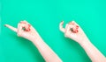 The Come Hither Hand Sign. Woman hand beckoning on isolated turquoise green color background. Female hand beckoning