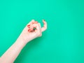 The Come Hither Hand Sign. Woman hand beckoning on isolated turquoise green color background. Female hand beckoning Royalty Free Stock Photo