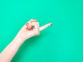 The Come Hither Hand Sign. Woman hand beckoning on isolated turquoise green color background. Female hand beckoning Royalty Free Stock Photo