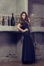 Come-hither woman in sexual evening dress in wine cellar. Luxury. Royalty Free Stock Photo