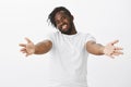 Come I want hugs. Friendly loving plump african man with beard, stretching hands towards camera to cuddle, smiling Royalty Free Stock Photo