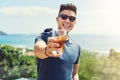 Come join us were here all summer long. Portrait of a handsome young man raising up his glass for a toast while relaxing Royalty Free Stock Photo