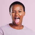 Come join the wild side. Studio shot of a young woman making a silly face against a pink background.