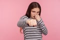 Come on, let`s fight! Portrait of aggressive angry woman in striped sweatshirt boxing to camera, punching Royalty Free Stock Photo