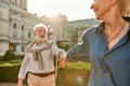 Come with me. Beautiful and happy elderly couple holding hands and smiling while spending time together outdoors on a Royalty Free Stock Photo