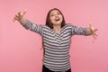 Come into my arms! Portrait of hospitable excited friendly woman in striped sweatshirt raising hands to embrace