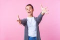 Come into my arms! Portrait of kind-hearted brunette teenage girl stretching hands to camera going to embrace. pink background