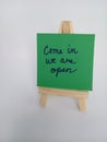 Come in we are open sign on a wood easel on a white background