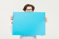 Come on over and put your copy here. A young man holding a blue placard up for your copyspace. Royalty Free Stock Photo