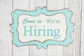 Come in we`re hiring text on a retro tin polka dot picture sign