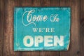 Come in we're open sign on an old wooden background Royalty Free Stock Photo