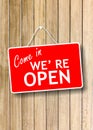 Come in we re open text sign on wooden background Royalty Free Stock Photo