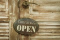 Come In We're Open on the wooden door, copyspace on the right, v Royalty Free Stock Photo