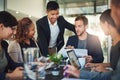 Come take a look at this. a group of businesspeople meeting in the boardroom.