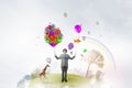 Comedian man with color balloons . Mixed media Royalty Free Stock Photo