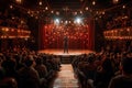 Comedian Performing Stand-up Comedy on Stage of Theater with Bright Lights in Front of Audience Royalty Free Stock Photo