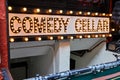 Comedy Cellar neon bulb lights sign going into basement in New York City