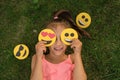 Comely pleasant girl covers eyes with funny and loving emoticons Royalty Free Stock Photo