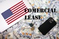 Comercial lease concept. USA flag, dollar money with keys, laptop and phone background Royalty Free Stock Photo