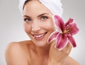 When it comes to beauty nature knows best. Cropped studio shot of a beautiful woman holding a flower against her face.