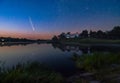 Comet C/2020 F3 Neowise in night sky over medieval Svirzh Castle, Lviv region, Ukraine