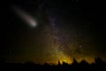 Comet with large dust and gas trails falls. Milky way stars and night forest landscape. Royalty Free Stock Photo