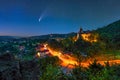 Comet in night starry sky over Bran town and Dracula Bran medieval castle, Transylvania regio, Romania Royalty Free Stock Photo