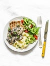 Comfort food - grilled pork chops, mashed potatoes with creamy mushroom sauce and fresh vegetable salad on a light background, top Royalty Free Stock Photo