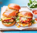 Comfort food and homemade meal recipe, burgers with meat and veggies for lunch or dinner on rustic board and blue table,