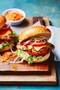 Comfort food and homemade meal recipe, burgers with meat and veggies for lunch or dinner on rustic board and blue table,