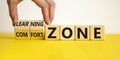 Comfort or learning zone symbol. Hand turns wooden cubes and changes words `comfort zone` to `learning zone`. Beautiful yellow Royalty Free Stock Photo