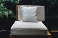 Comfort wooden chair with soft cotton pillow and cushion in low light ready to rest within decorative garden living room style.