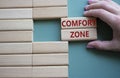 Comfort zone symbol. Concept word Comfort zone on wooden blocks. Businessman hand. Beautiful grey green background. Business and Royalty Free Stock Photo