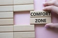 Comfort zone symbol. Concept word Comfort zone on wooden blocks. Businessman hand. Beautiful pink background. Business and Comfort Royalty Free Stock Photo