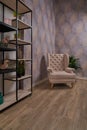 Comfortable arm chair in interior living room with pastel wall and wooden oak floor