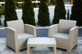 Comfortable armchairs and coffee table outdoors. Beautiful rattan garden furniture