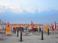 Comfortable beach with sun beds and orange umbrellas Royalty Free Stock Photo