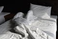 Comfortable bed with white linen at home or Bedroom with bed and bedding White pillows, duvet. Messy bed. hotel room concept. An Royalty Free Stock Photo