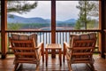 comfortable chairs on a cabin porch with lake view