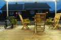 Comfortable chairs for relaxing in the illuminated gazebo in the backyard